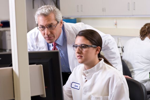 scientists looking at a computer screen