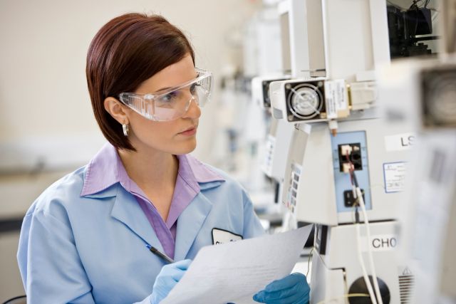 researcher inspecting lab equipment