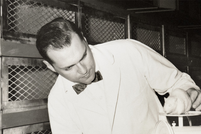 Photo of Henry Foster with a white mouse on a scale