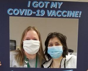Image of two women after receiving their COVID vaccine