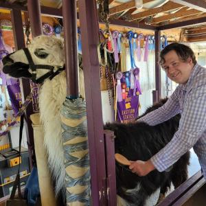 Thomas, a disabled man, with a llama. 