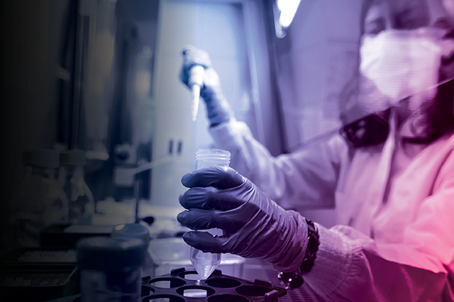 Scientist working in a lab with an overlay of the Vital Science colors.