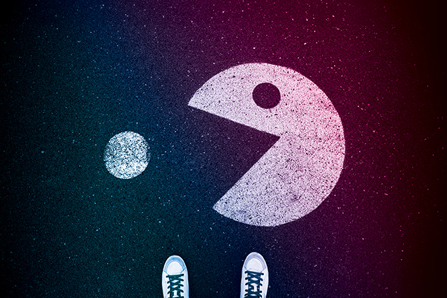 Chalk drawing of Packman on the ground with feet peaking into the frame from the bottom corner, overlaid with vital science colors.