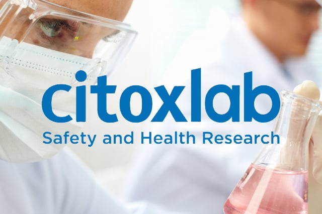 Citoxlab logo on background of researcher holding a flask