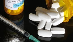 Pill bottle and syringe depicting drug abuse liability testing.