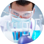A male technician in safety gear reviews dosing and sampling of studies