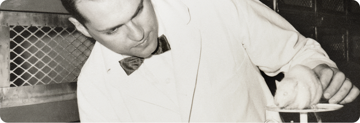 Photo of Henry Foster with a white mouse on a scale