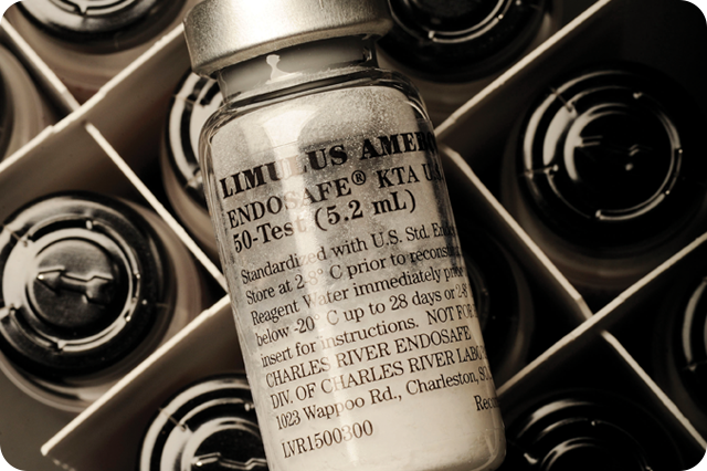 A close-up shot of a vial labeled Limulus Amebocyte Lysate (LAL) Endosafe 50-Test (5.2 mL) in a cardboard tray with other vials.