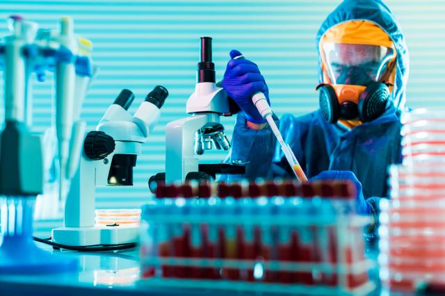 Technician pipetting in laboratory