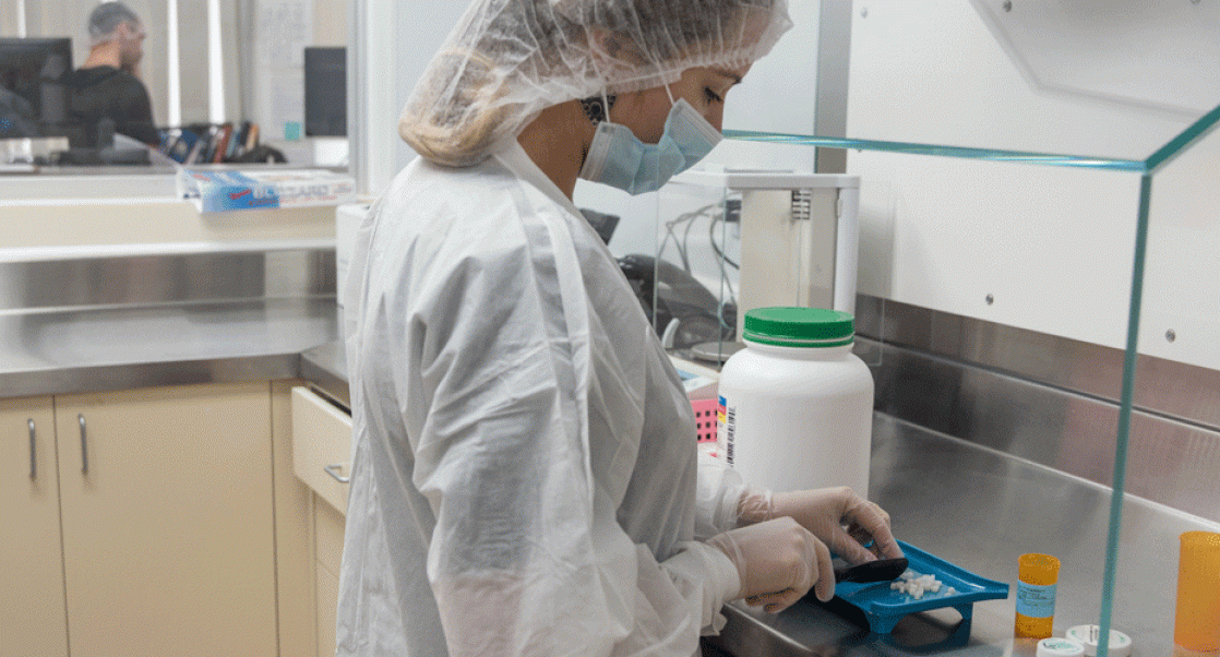 Pharmacist compounding a drug