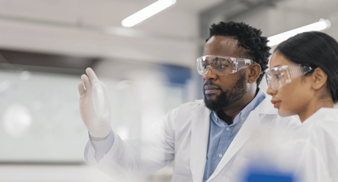 Two scientists looking at petri dish