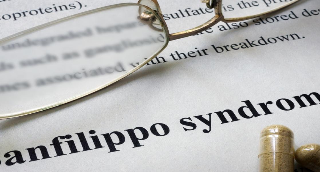 Pair of eyeglasses on an article about Sanfilippo syndrome (aka mucopolysaccharidosis type III or MPS III)