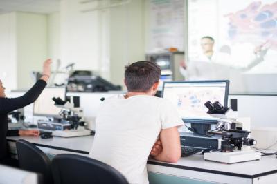 College students attending a medical lecture. Story is about how internships can lead to cell and gene therapy careers