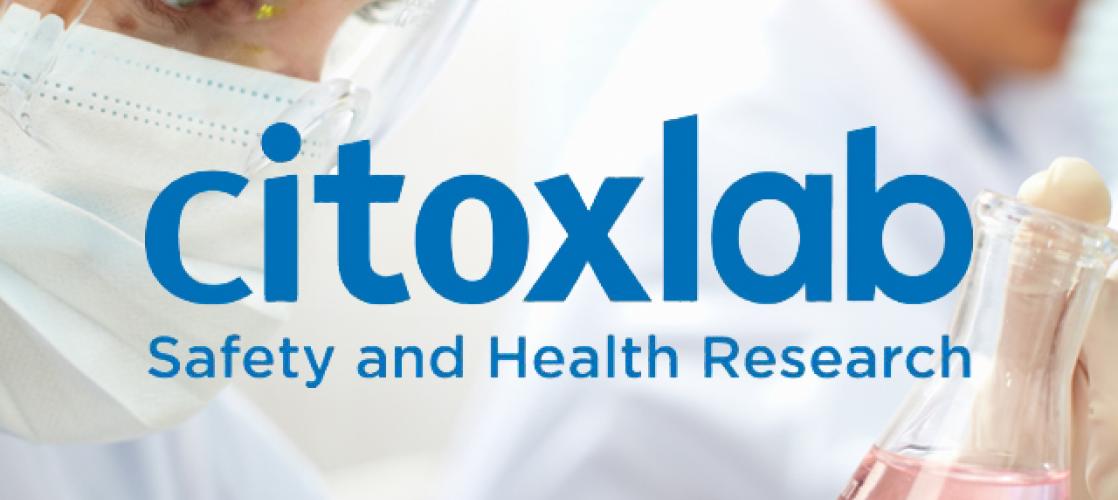 Citoxlab logo on background of researcher holding a flask